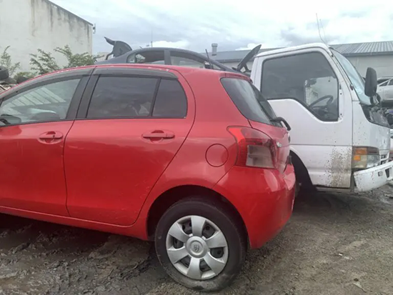 Tow truck transporting three scrap cars for removal in whanganui
